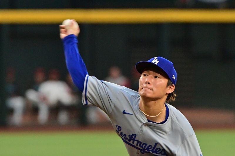 May 1, 2024; Phoenix, Arizona, USA;  Los Angeles Dodgers pitcher Yoshinobu Yamamoto (18) throws in the first inning against the Arizona Diamondbacks at Chase Field. Mandatory Credit: Matt Kartozian-USA TODAY Sports