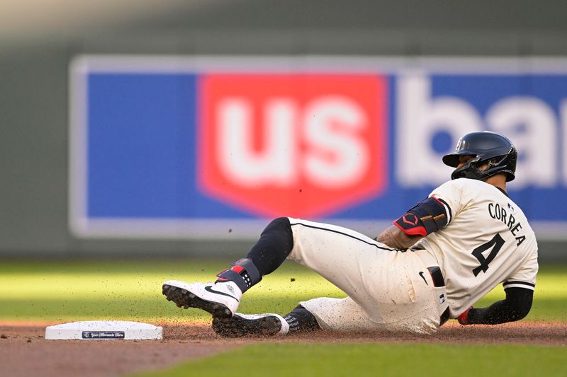 Jul 3, 2024; Minneapolis, Minnesota, USA; Minnesota Twins infielder Carlos Correa (4) slides safely into second for a double against the Detroit Tigers during the first inning at Target Field. Mandatory Credit: Nick Wosika-USA TODAY Sports