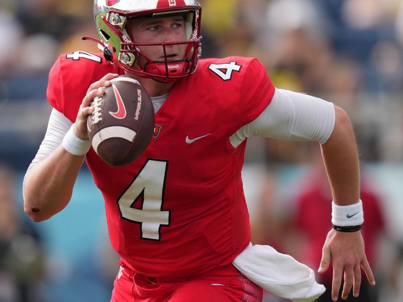 Dec 18, 2021; Boca Raton, Florida, USA; Western Kentucky Hilltoppers quarterback Bailey Zappe (4) scrambles with the ball against the Appalachian State Mountaineers during the second half in the 2021 Boca Raton Bowl at FAU Stadium. Mandatory Credit: Jasen Vinlove-USA TODAY Sports