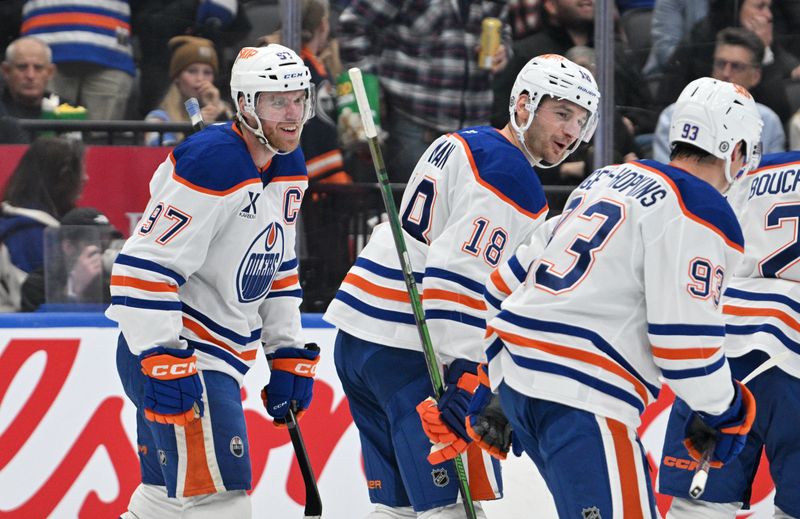 Nov 16, 2024; Toronto, Ontario, CAN;  Edmonton Oilers forward Connor McDavid (97) celebrates with forward Zach Hyman (18) and forward Ryan Nugent-Hopkins (93) after scoring against the Toronto Maple Leafs in the second period at Scotiabank Arena. Mandatory Credit: Dan Hamilton-Imagn Images