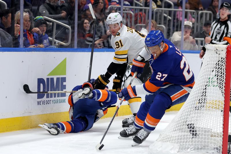 Nov 4, 2025; Elmont, New York, USA; New York Islanders left wing Anders Lee (27) controls the puck against the Boston Bruins as Bruins defenseman Nikita Zadorov (91) hits Islanders defenseman Matthew Schaefer (48) during the second period at UBS Arena. Mandatory Credit: Brad Penner-Imagn Images
