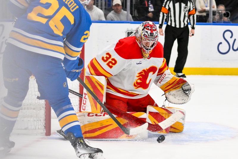 Nov 11, 2025; St. Louis, Missouri, USA; Calgary Flames goaltender Dustin Wolf (32) defends the net against St. Louis Blues right wing Jordan Kyrou (25) during the second period at Enterprise Center. Mandatory Credit: Jeff Curry-Imagn Images