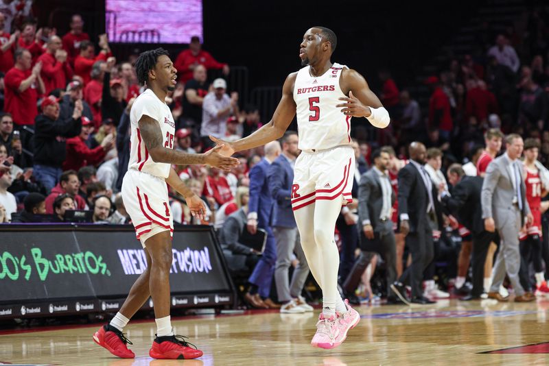 Feb 10, 2024; Piscataway, New Jersey, USA; Rutgers Scarlet Knights forward Aundre Hyatt (5) celebrates with guard Jeremiah Williams (25) during the first half against the Wisconsin Badgers at Jersey Mike's Arena. Mandatory Credit: Vincent Carchietta-USA TODAY Sports