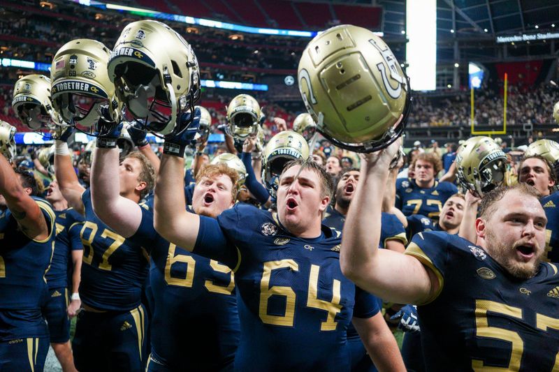 Sep 25, 2021; Atlanta, Georgia, USA; Georgia Tech Yellow Jackets offensive lineman Matthew Morgan (69) and offensive lineman Nick Pendley (64) and offensive lineman Mikey Minihan (57) celebrate after a victory against the North Carolina Tar Heels at Mercedes-Benz Stadium. Mandatory Credit: Brett Davis-USA TODAY Sports