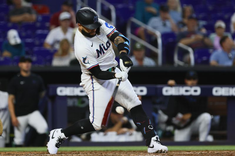 Apr 17, 2024; Miami, Florida, USA; Miami Marlins third baseman Emmanuel Rivera (15) hits a single against the San Francisco Giants during the eighth inning at loanDepot Park. Mandatory Credit: Sam Navarro-USA TODAY Sports