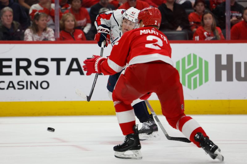 Apr 9, 2024; Detroit, Michigan, USA; Washington Capitals left wing Beck Malenstyn (47) takes a shot defended by Detroit Red Wings defenseman Olli Maatta (2) in the third period at Little Caesars Arena. Mandatory Credit: Rick Osentoski-USA TODAY Sports