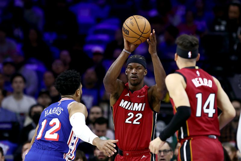 PHILADELPHIA, PENNSYLVANIA - APRIL 17: Jimmy Butler #22 of the Miami Heat attempts a pass past Tobias Harris #12 of the Philadelphia 76ers during the first quarter of the Eastern Conference Play-In Tournament at the Wells Fargo Center on April 17, 2024 in Philadelphia, Pennsylvania. NOTE TO USER: User expressly acknowledges and agrees that, by downloading and or using this photograph, User is consenting to the terms and conditions of the Getty Images License Agreement. (Photo by Tim Nwachukwu/Getty Images)