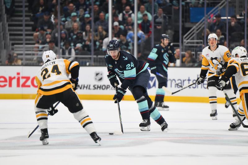 Jan 25, 2025; Seattle, Washington, USA; Seattle Kraken defenseman Jamie Oleksiak (24) advances the puck against the Pittsburgh Penguins during the first period at Climate Pledge Arena. Mandatory Credit: Steven Bisig-Imagn Images