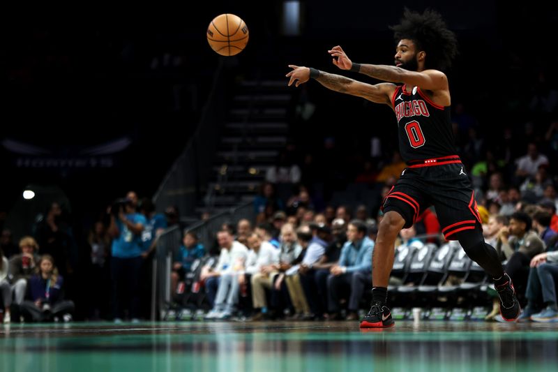 CHARLOTTE, NORTH CAROLINA - JANUARY 31: Coby White #0 of the Chicago Bulls passes the ball during the first half of an NBA game against the Charlotte Hornets at Spectrum Center on January 31, 2024 in Charlotte, North Carolina. NOTE TO USER: User expressly acknowledges and agrees that, by downloading and or using this photograph, User is consenting to the terms and conditions of the Getty Images License Agreement. (Photo by David Jensen/Getty Images)