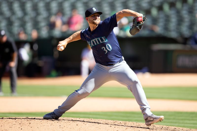 Sep 5, 2024; Oakland, California, USA; Seattle Mariners pitcher Austin Voth (30) delivers a pitch against the Oakland Athletics during the eighth inning at Oakland-Alameda County Coliseum. Mandatory Credit: D. Ross Cameron-Imagn Images