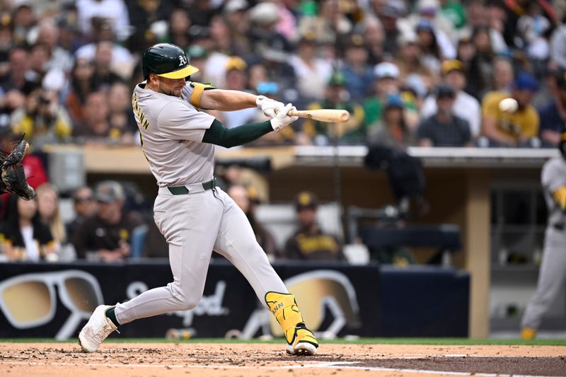 Jun 10, 2024; San Diego, California, USA; Oakland Athletics shortstop Max Schuemann (12) hits a single against the San Diego Padres during the second inning at Petco Park. Mandatory Credit: Orlando Ramirez-USA TODAY Sports