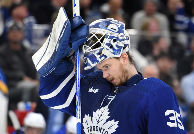 Jan 3, 2023; Toronto, Ontario, CAN; Toronto Maple Leafs goalie Ilya Samsonov (35) adjusts his mask before play resumes against the St. Louis Blues in the second period at Scotiabank Arena. Mandatory Credit: Dan Hamilton-USA TODAY Sports