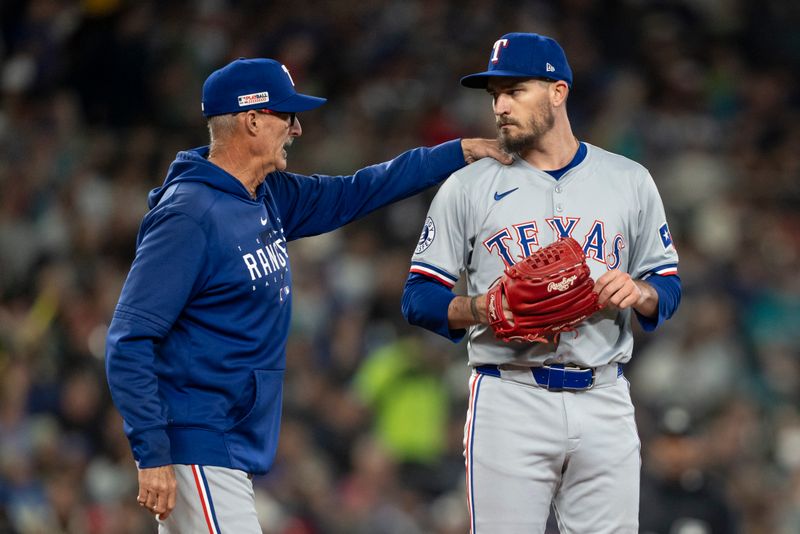 Jun 14, 2024; Seattle, Washington, USA; Texas Rangers starting pitcher Andrew Heaney (44), left, meets at the mound with pitching coach Mike Maddux during the fourth inning against the Seattle Mariners at T-Mobile Park. Mandatory Credit: Stephen Brashear-USA TODAY Sports