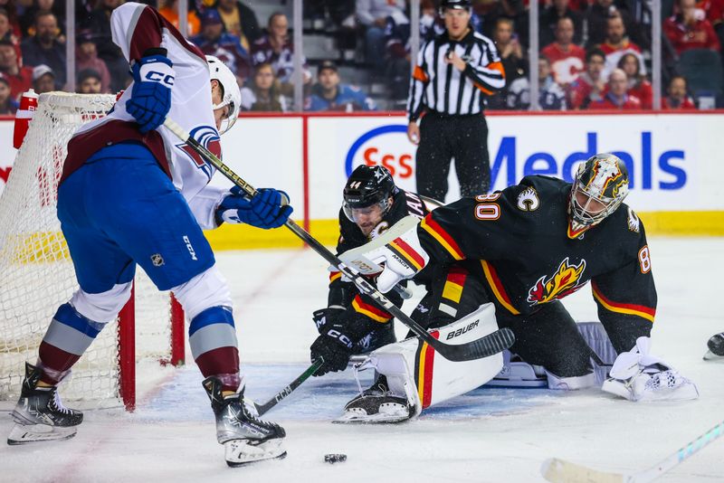 Mar 12, 2024; Calgary, Alberta, CAN; Calgary Flames goaltender Dan Vladar (80) makes a save against the Colorado Avalanche during the first period at Scotiabank Saddledome. Mandatory Credit: Sergei Belski-USA TODAY Sports