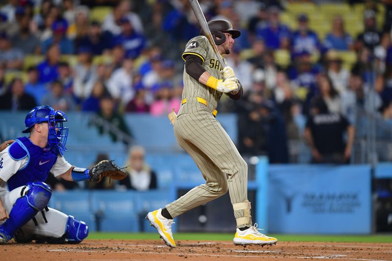 Sep 24, 2024; Los Angeles, California, USA; San Diego Padres center fielder Jackson Merrill (3) hits a single against the Los Angeles Dodgers during the second inning at Dodger Stadium. Mandatory Credit: Gary A. Vasquez-Imagn Images