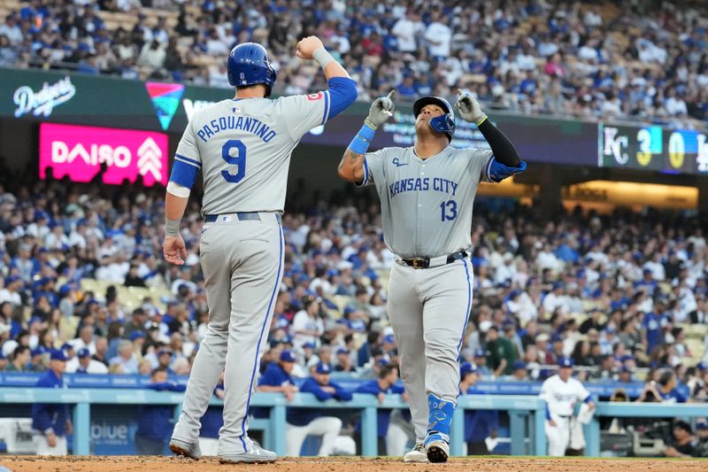 Jun 14, 2024; Los Angeles, California, USA; Kansas City Royals catcher Salvador Perez (13) celebrates with first baseman Vinnie Pasquantino (9) after hitting a three-run home run in the fourth inning against the Los Angeles Dodgers at Dodger Stadium. Mandatory Credit: Kirby Lee-USA TODAY Sports