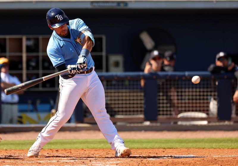 Feb 27, 2024; Port Charlotte, Florida, USA;  Tampa Bay Rays catcher Rene Pinto (50) hits a RBI double during the fifth inning against the New York Yankees at Charlotte Sports Park. Mandatory Credit: Kim Klement Neitzel-USA TODAY Sports