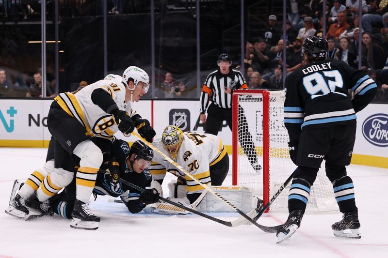 Oct 19, 2025; Salt Lake City, Utah, USA; Boston Bruins goaltender Joonas Korpisalo (70) covers the puck after a save on a shot by Utah Mammoth center Logan Cooley (92) during the first period at Delta Center. Mandatory Credit: Rob Gray-Imagn Images