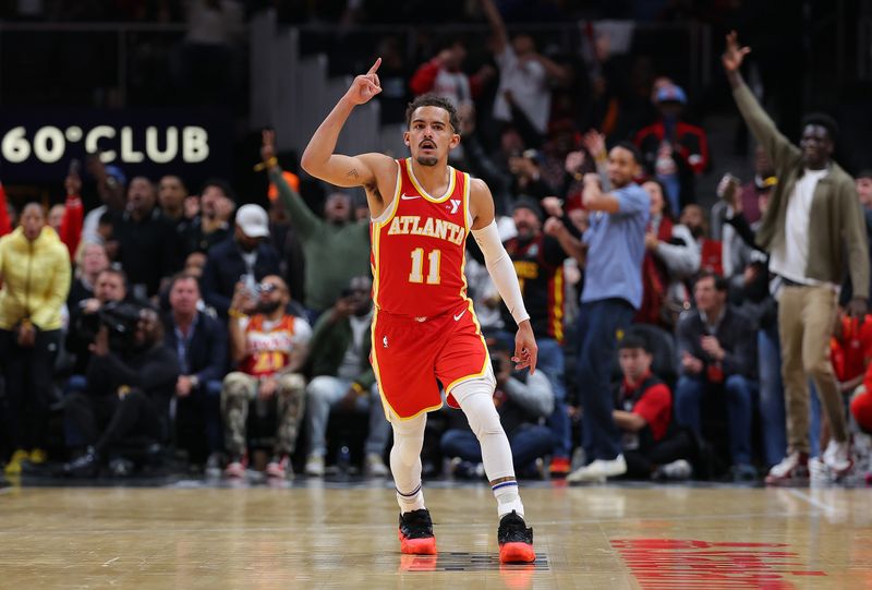 ATLANTA, GEORGIA - DECEMBER 06:  Trae Young #11 of the Atlanta Hawks reacts after a three-point basket against the Brooklyn Nets during the fourth quarter at State Farm Arena on December 06, 2023 in Atlanta, Georgia.  NOTE TO USER: User expressly acknowledges and agrees that, by downloading and/or using this photograph, user is consenting to the terms and conditions of the Getty Images License Agreement.  (Photo by Kevin C. Cox/Getty Images)