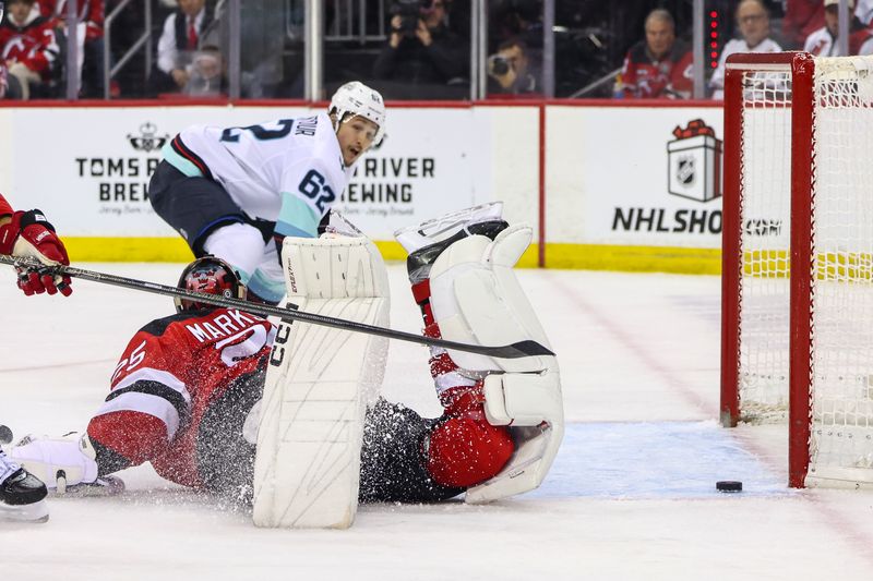 Dec 6, 2024; Newark, New Jersey, USA; Seattle Kraken defenseman Brandon Montour (62) shoots the puck wide of the net against the New Jersey Devils during the third period at Prudential Center. Mandatory Credit: Ed Mulholland-Imagn Images