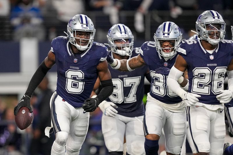 Dallas Cowboys safety Donovan Wilson (6) holds the ball after intercepting a pass by Detroit Lions quarterback Jared Goff during the second half of an NFL football game, Saturday, Dec. 30, 2023, in Arlington, Texas. (AP Photo/Sam Hodde)