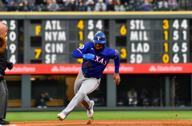 May 11, 2024; Denver, Colorado, USA; Texas Rangers designated hitter Ezequiel Duran (20) runs to third base agains the Colorado Rockies during the fifth inning at Coors Field. Mandatory Credit: John Leyba-USA TODAY Sports