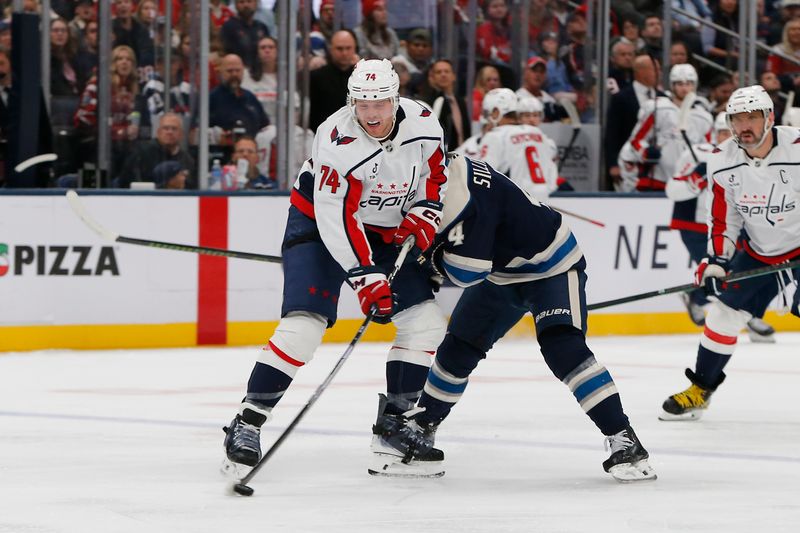 Oct 24, 2025; Columbus, Ohio, USA; Columbus Blue Jackets center Cole Sillinger (4) checks Washington Capitals defenseman John Carlson (74) during the second period at Nationwide Arena. Mandatory Credit: Russell LaBounty-Imagn Images