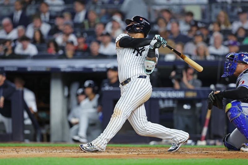 Oct 5, 2024; Bronx, New York, USA; New York Yankees second base Gleyber Torres (25) hits a two run home run during the third inning against the Kansas City Royals during game one of the ALDS for the 2024 MLB Playoffs at Yankee Stadium. Mandatory Credit: Brad Penner-Imagn Images