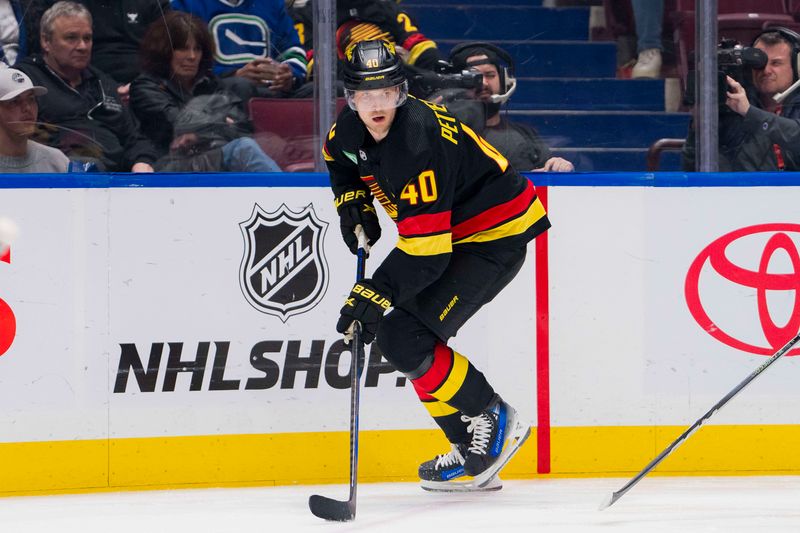 Feb 29, 2024; Vancouver, British Columbia, CAN; Vancouver Canucks forward Elias Pettersson (40) handles the puck against the Los Angeles Kings in the third period at Rogers Arena. Kings won 5-1. Mandatory Credit: Bob Frid-USA TODAY Sports