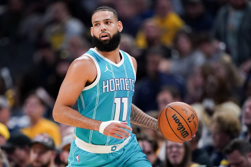 INDIANAPOLIS, INDIANA - OCTOBER 17: Cody Martin #11 of the Charlotte Hornets dribbles the ball in the first quarter against the Indiana Pacers during a preseason game at Gainbridge Fieldhouse on October 17, 2024 in Indianapolis, Indiana. NOTE TO USER: User expressly acknowledges and agrees that, by downloading and or using this photograph, User is consenting to the terms and conditions of the Getty Images License Agreement. (Photo by Dylan Buell/Getty Images)