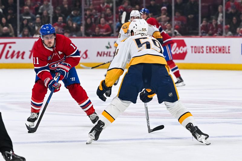 Dec 10, 2023; Montreal, Quebec, CAN; Montreal Canadiens right wing Brendan Gallagher (11) plays the puck against Nashville Predators defenseman Roman Josi (59) during the first period at Bell Centre. Mandatory Credit: David Kirouac-USA TODAY Sports