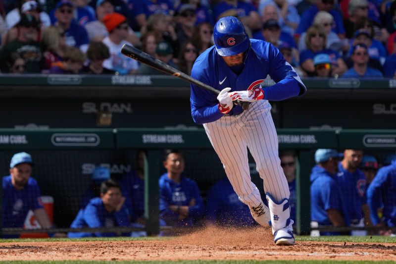 Mar 14, 2024; Mesa, Arizona, USA; Chicago Cubs starting pitcher Shota Imanaga (18) jumps out of the way of a wild pitch against the Oakland Athletics in the third inning at Sloan Park. Mandatory Credit: Rick Scuteri-USA TODAY Sports