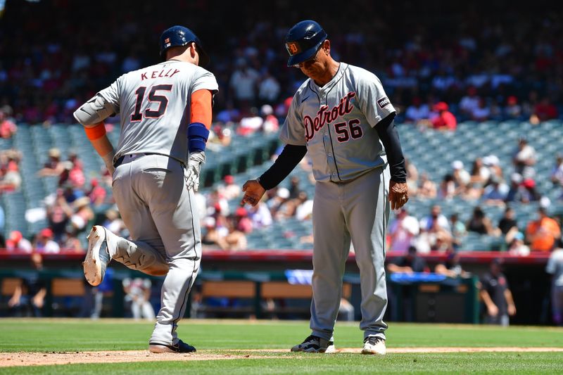 Jun 27, 2024; Anaheim, California, USA; Detroit Tigers catcher Carson Kelly (15) is greeted by third base coach Joey Cora (56) after hitting a three run home run against the Los Angeles Angels during the fifth inning at Angel Stadium. Mandatory Credit: Gary A. Vasquez-USA TODAY Sports