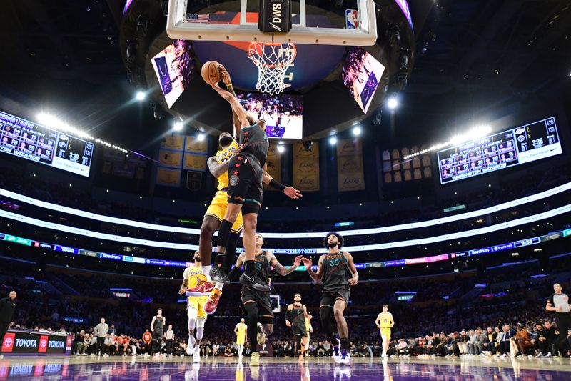 LOS ANGELES, CA - FEBRUARY 29: (EDITORS NOTE: Sequence 2 of 3) LeBron James #23 of the Los Angeles Lakers blocks Jordan Poole #13 of the Washington Wizards during the game on February 29, 2024 at Crypto.Com Arena in Los Angeles, California. NOTE TO USER: User expressly acknowledges and agrees that, by downloading and/or using this Photograph, user is consenting to the terms and conditions of the Getty Images License Agreement. Mandatory Copyright Notice: Copyright 2024 NBAE (Photo by Adam Pantozzi/NBAE via Getty Images)