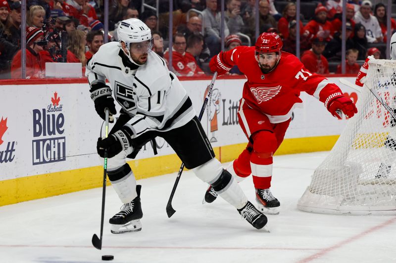 Jan 13, 2024; Detroit, Michigan, USA;  Los Angeles Kings center Anze Kopitar (11) skates with the puck chased by Detroit Red Wings center Dylan Larkin (71) in the second period at Little Caesars Arena. Mandatory Credit: Rick Osentoski-USA TODAY Sports