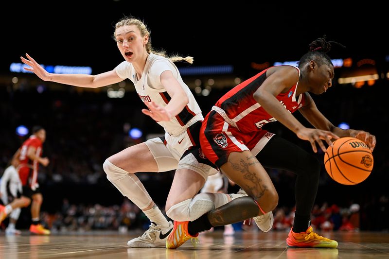 Mar 29, 2024; Portland, OR, USA; Stanford Cardinal forward Cameron Brink (22) and NC State Wolfpack guard Saniya Rivers (22) collide as they dive for the ball during the second half in the semifinals of the Portland Regional of the 2024 NCAA Tournament at the Moda Center at the Moda Center. Mandatory Credit: Troy Wayrynen-USA TODAY Sports