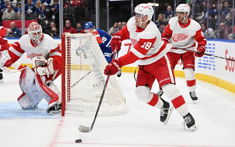 Jan 14, 2024; Toronto, Ontario, CAN;  Detroit Red Wings forward Andrew Copp (18) passes the puck against the Toronto Maple Leafs in the third period at Scotiabank Arena. Mandatory Credit: Dan Hamilton-USA TODAY Sports