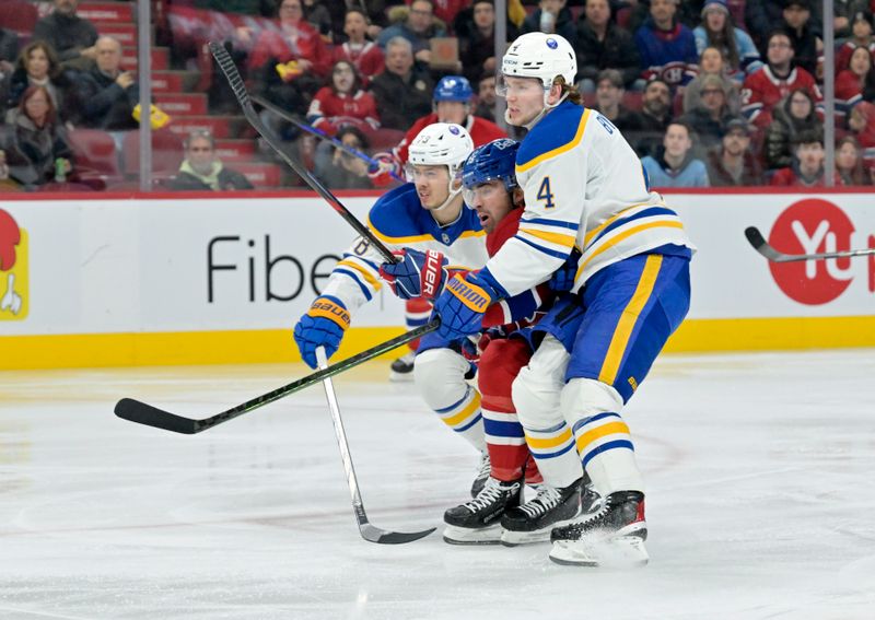 Mar 3, 2025; Montreal, Quebec, CAN; Montreal Canadiens forward Alex Newhook (15) squeezes by Buffalo Sabres defenseman Jacob Bryson (78) and defenseman Bowen Byram (4) during the second period at the Bell Centre. Mandatory Credit: Eric Bolte-Imagn Images