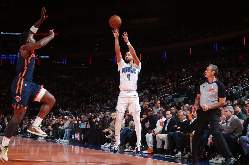 NEW YORK, NY - DECEMBER 3: Jalen Suggs #4 of the Orlando Magic shoots a three point basket during the game  against the New York Knicks during the Emirates NBA Cup on December 3, 2024 at Madison Square Garden in New York City, New York.  NOTE TO USER: User expressly acknowledges and agrees that, by downloading and or using this photograph, User is consenting to the terms and conditions of the Getty Images License Agreement. Mandatory Copyright Notice: Copyright 2024 NBAE  (Photo by Nathaniel S. Butler/NBAE via Getty Images)