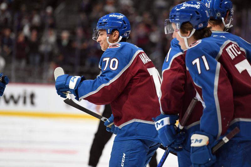 Sep 29, 2024; Denver, Colorado, USA; Colorado Avalanche defenseman Sam Malinski (70) celebrates with teammates after a goal during the second period against the Utah Hockey Club at Ball Arena. Mandatory Credit: Christopher Hanewinckel-Imagn Images