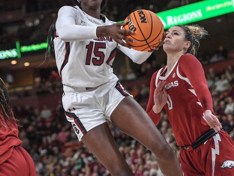 Mar 3, 2023; Greenville, SC, USA; South Carolina forward Laeticia Amihere (15) shoots near Arkansas guard Saylor Poffenbarger (0) during the fourth quarter at Bon Secours Wellness Arena. Mandatory Credit: Ken Ruinard-USA TODAY Sports