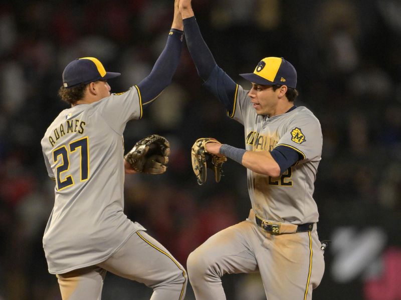 Jun 19, 2024; Anaheim, California, USA; Milwaukee Brewers shortstop Willy Adames (27) and left fielder Christian Yelich (22) celebrate after the final out of the ninth inning defeating the Los Angeles Angels at Angel Stadium. Mandatory Credit: Jayne Kamin-Oncea-USA TODAY Sports