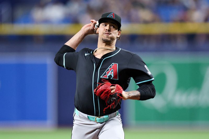 Aug 16, 2024; St. Petersburg, Florida, USA; Arizona Diamondbacks pitcher Justin Martinez (63) throws a pitch against the Tampa Bay Rays in the ninth inning at Tropicana Field. Mandatory Credit: Nathan Ray Seebeck-USA TODAY Sports