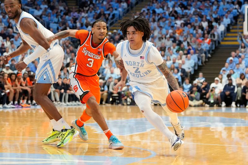 Jan 13, 2024; Chapel Hill, North Carolina, USA;  North Carolina Tar Heels guard Elliot Cadeau (2) dribbles as Syracuse Orange guard Judah Mintz (3) defends in the second half at Dean E. Smith Center. Mandatory Credit: Bob Donnan-USA TODAY Sports