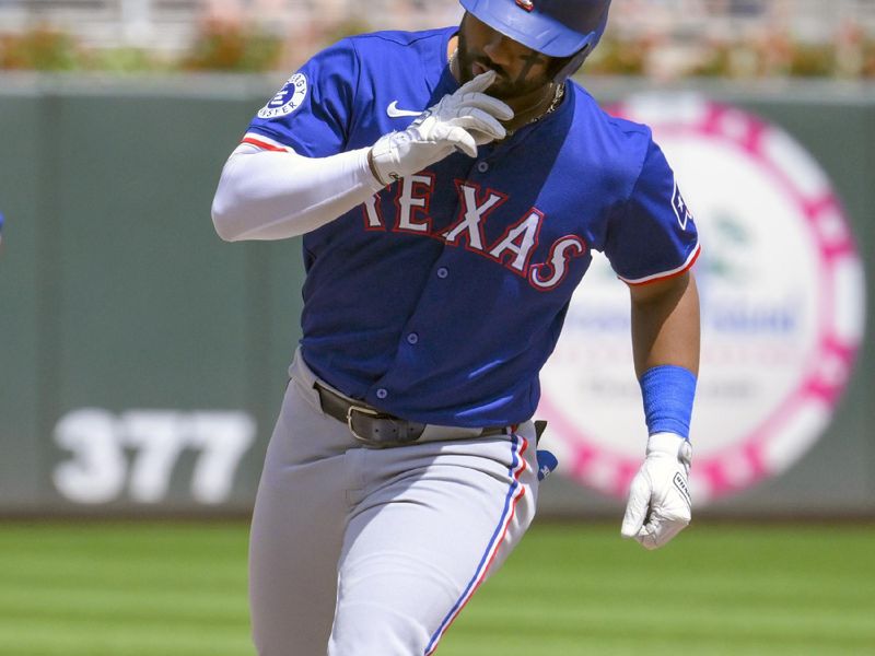 May 25, 2024; Minneapolis, Minnesota, USA;  Texas Rangers outfielder Ezequiel Duran (20) makes the sign to hush as he rounds third basa after hitting a solo home run against the Minnesota Twins during the fifth inning at Target Field. Mandatory Credit: Nick Wosika-USA TODAY Sports