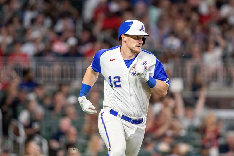 Sep 9, 2023; Cumberland, Georgia, USA; Atlanta Braves catcher Sean Murphy (12) hits single against Pittsburgh Pirates during seventh inning at Truist Park. Mandatory Credit: Jordan Godfree-USA TODAY Sports