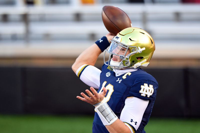 Nov 14, 2020; Chestnut Hill, Massachusetts, USA; Notre Dame Fighting Irish quarterback Ian Book (12) throws the ball during warms ups before a game against the Boston College Eagles at Alumni Stadium. Mandatory Credit: Brian Fluharty-USA TODAY Sports