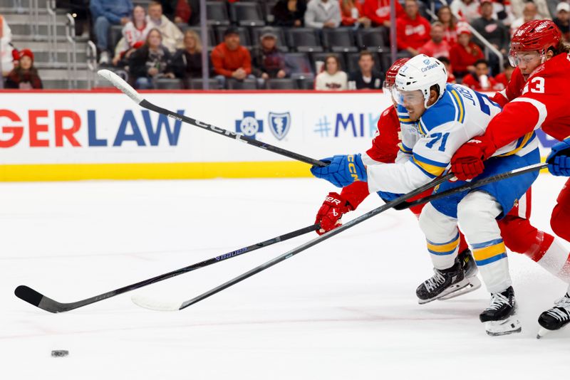 Oct 25, 2025; Detroit, Michigan, USA;  St. Louis Blues right wing Mathieu Joseph (71) Detroit Red Wings defenseman Simon Edvinsson (77) and defenseman Moritz Seider (53) battle for the puck in the first period at Little Caesars Arena. Mandatory Credit: Rick Osentoski-Imagn Images