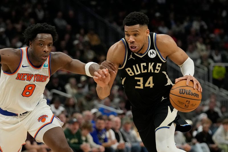 MILWAUKEE, WISCONSIN - APRIL 07: Giannis Antetokounmpo #34 of the Milwaukee Bucks dribbles the ball against OG Anunoby #8 of the New York Knicks during the first half at Fiserv Forum on April 07, 2024 in Milwaukee, Wisconsin. NOTE TO USER: User expressly acknowledges and agrees that, by downloading and or using this photograph, User is consenting to the terms and conditions of the Getty Images License Agreement. (Photo by Patrick McDermott/Getty Images)