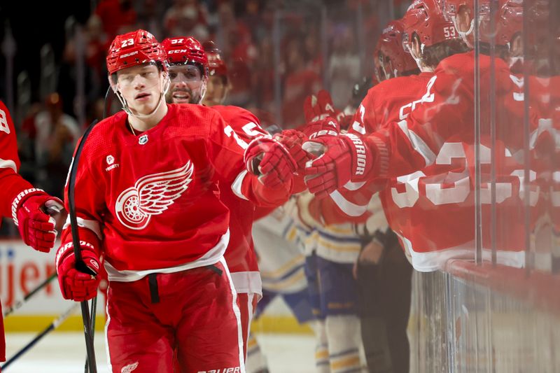 Apr 7, 2024; Detroit, Michigan, USA; Detroit Red Wings left wing Lucas Raymond (23) receives congratulations from teammates after scoring in the first period against the Buffalo Sabres at Little Caesars Arena. Mandatory Credit: Rick Osentoski-USA TODAY Sports